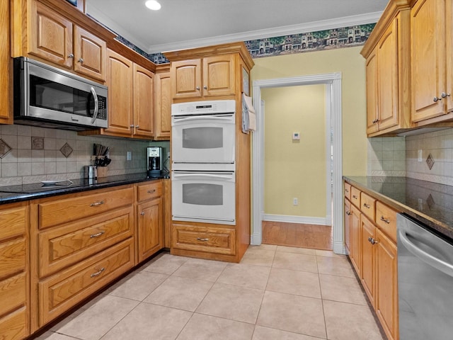 kitchen featuring backsplash, ornamental molding, appliances with stainless steel finishes, and light tile patterned floors