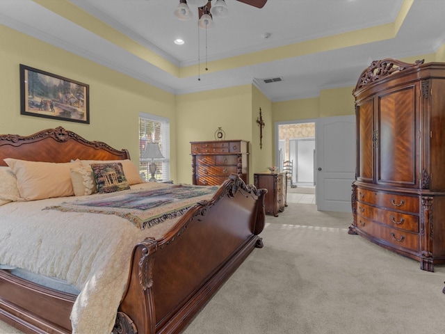 carpeted bedroom featuring crown molding, ceiling fan, and a tray ceiling