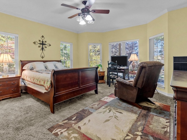 bedroom featuring multiple windows, crown molding, light colored carpet, and ceiling fan