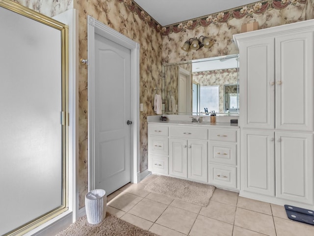 bathroom with an enclosed shower, vanity, and tile patterned floors