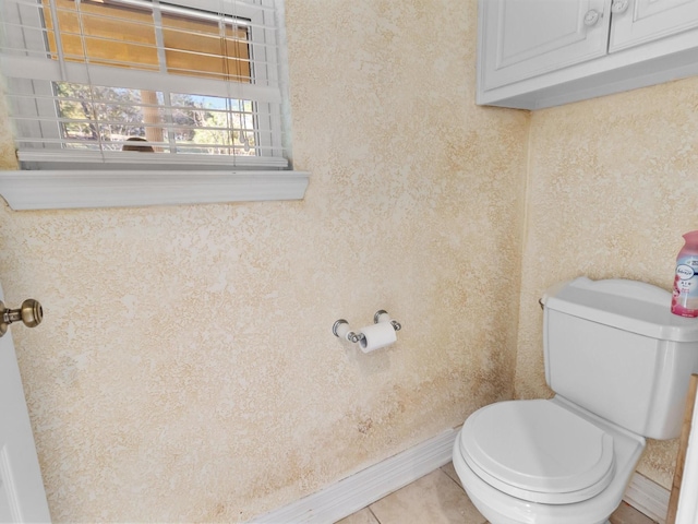 bathroom with toilet and tile patterned flooring