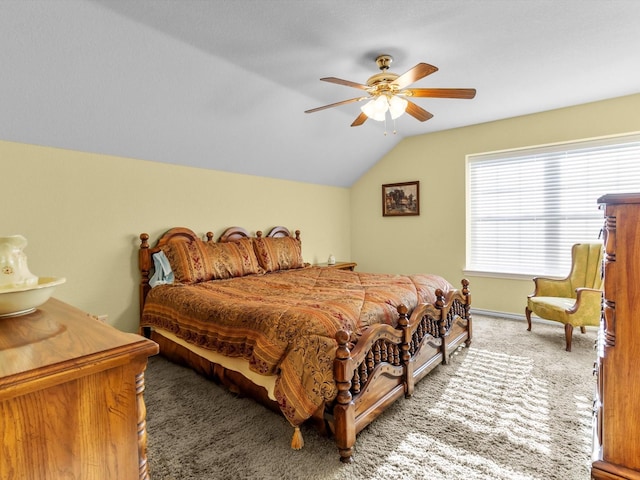 bedroom with ceiling fan, carpet floors, and vaulted ceiling