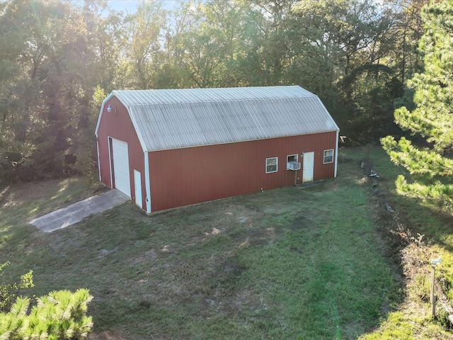 view of outdoor structure with a yard and a garage