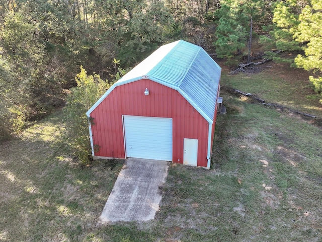 view of outbuilding featuring a garage and a lawn