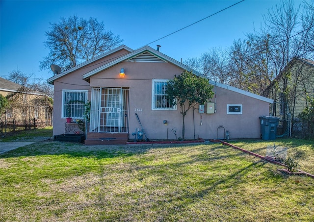 rear view of property with a yard