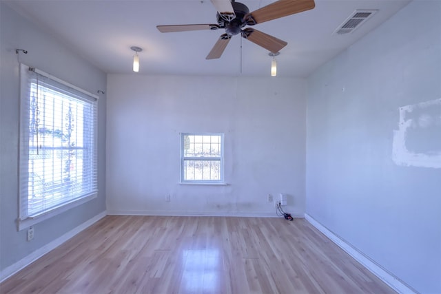 empty room featuring ceiling fan and light hardwood / wood-style floors