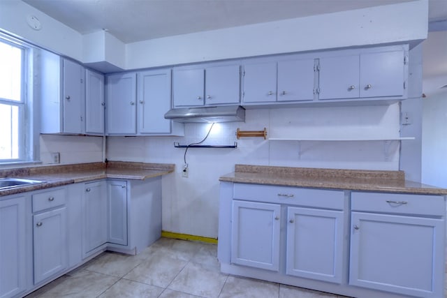 kitchen with white cabinetry and light tile patterned floors