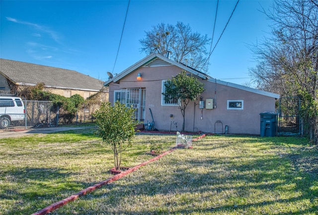 rear view of house featuring a yard