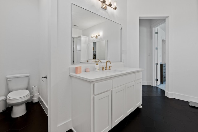 bathroom featuring tile patterned flooring, vanity, and toilet