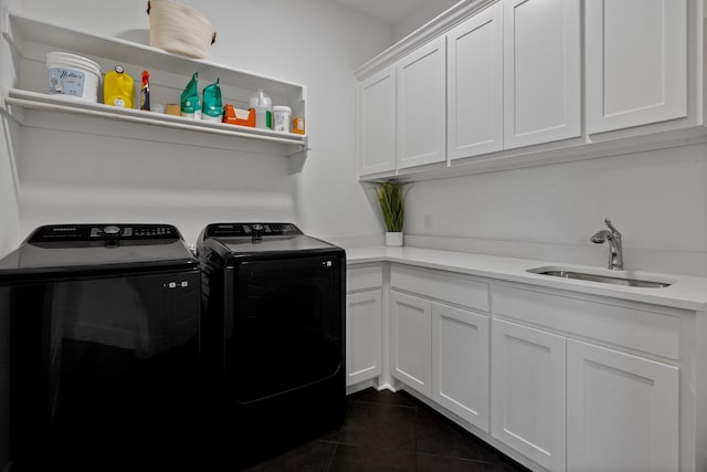 laundry room featuring cabinets, independent washer and dryer, dark tile patterned flooring, and sink