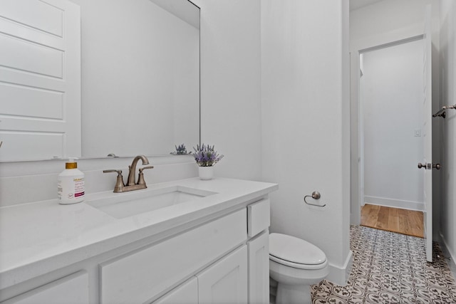 bathroom with vanity, tile patterned floors, and toilet