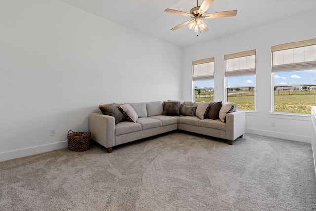 carpeted living room with ceiling fan