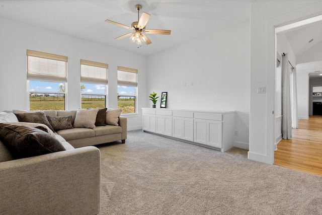 carpeted living room with ceiling fan