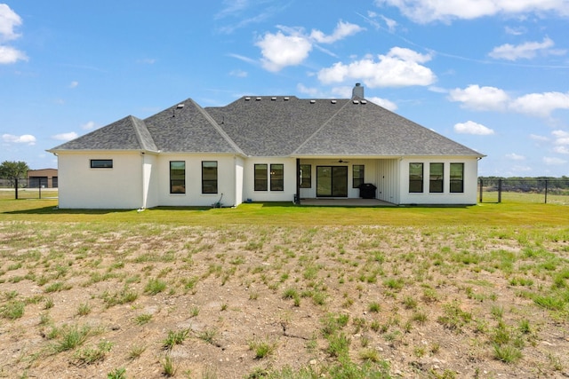 rear view of property with a yard and a patio area