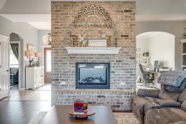 living room with hardwood / wood-style flooring and a brick fireplace