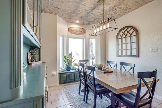 tiled dining room with lofted ceiling and brick ceiling