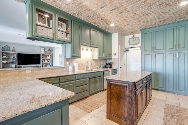 kitchen with sink, stainless steel dishwasher, brick ceiling, and green cabinets