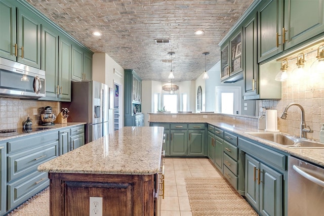 kitchen featuring green cabinets, brick ceiling, and stainless steel appliances