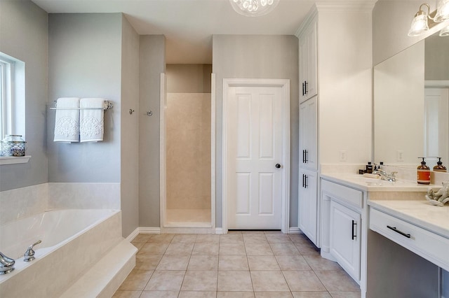 bathroom featuring tile patterned flooring, vanity, separate shower and tub, and a notable chandelier