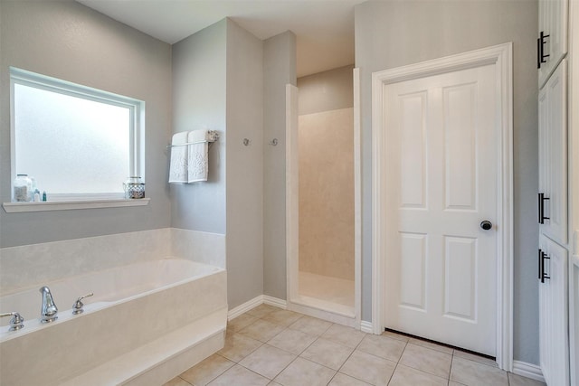 bathroom featuring tile patterned flooring and separate shower and tub