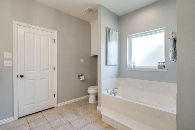 bathroom featuring tile patterned floors, toilet, and a bathtub