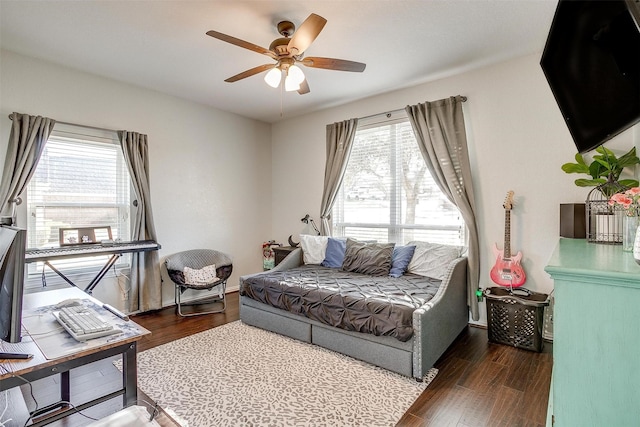 bedroom with dark wood-type flooring and ceiling fan