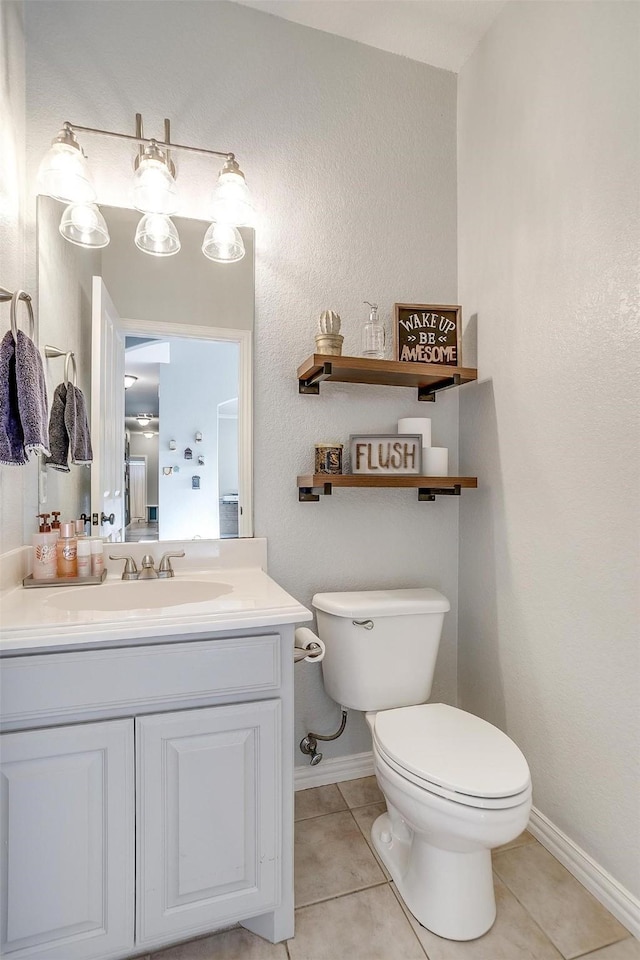 bathroom with vanity, tile patterned floors, and toilet