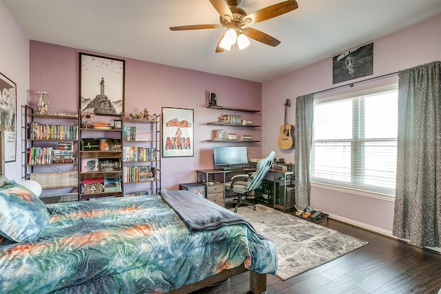 bedroom with dark wood-type flooring and ceiling fan