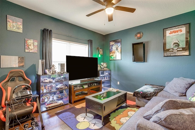 living room with hardwood / wood-style floors and ceiling fan