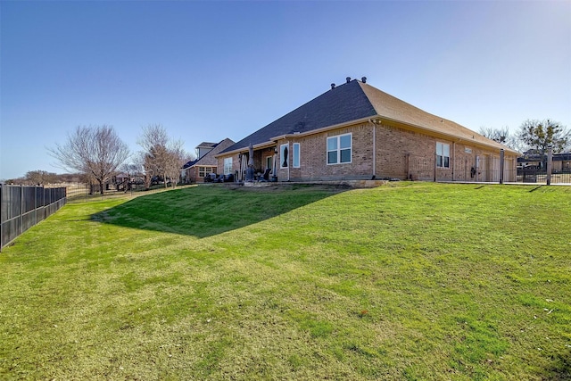 rear view of house with a lawn