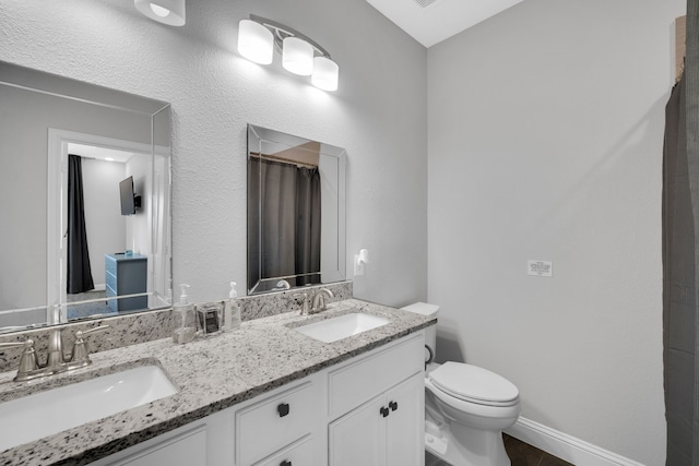 bathroom featuring vanity and toilet