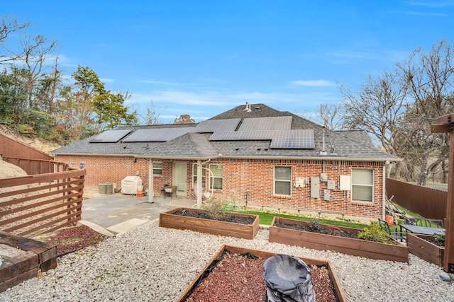 rear view of property with a patio and central AC