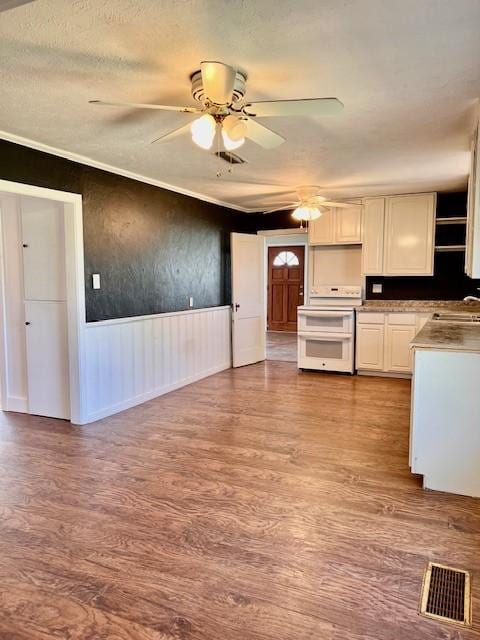 kitchen with white cabinetry, ceiling fan, range with two ovens, and light wood-type flooring