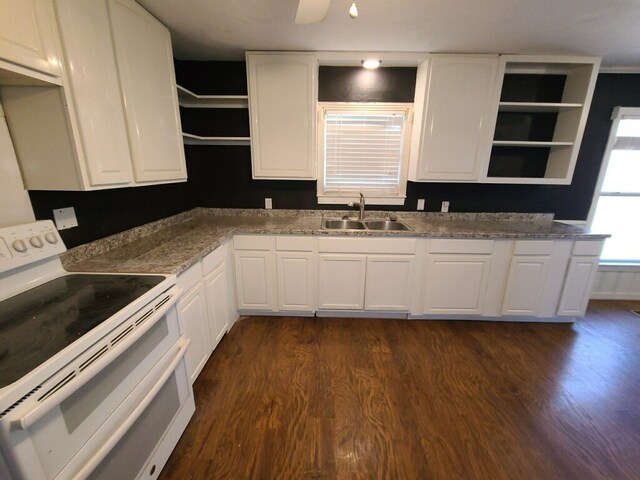 kitchen featuring dark hardwood / wood-style floors, sink, white cabinets, dark stone counters, and double oven range