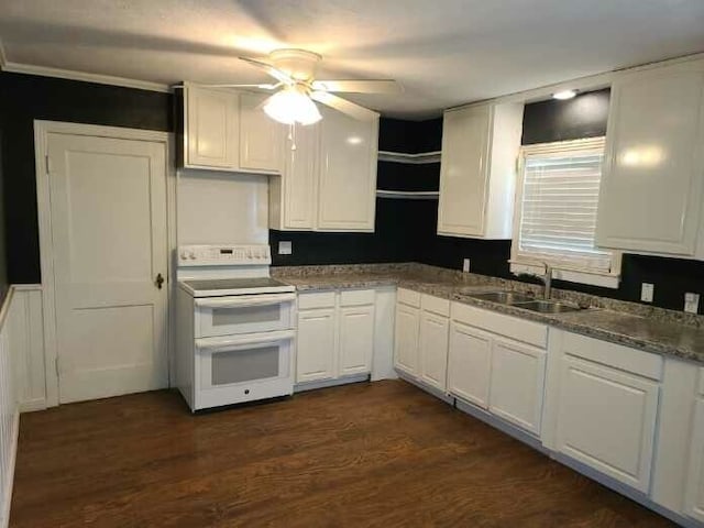 kitchen with sink, dark wood-type flooring, stone counters, white cabinetry, and range with two ovens