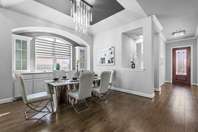 dining room with dark wood-style floors, ornamental molding, a chandelier, and baseboards