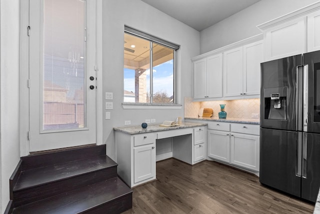 kitchen featuring light stone counters, dark wood finished floors, tasteful backsplash, white cabinetry, and fridge with ice dispenser