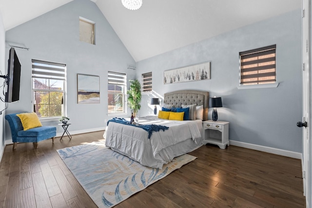 bedroom with high vaulted ceiling, multiple windows, baseboards, and hardwood / wood-style flooring