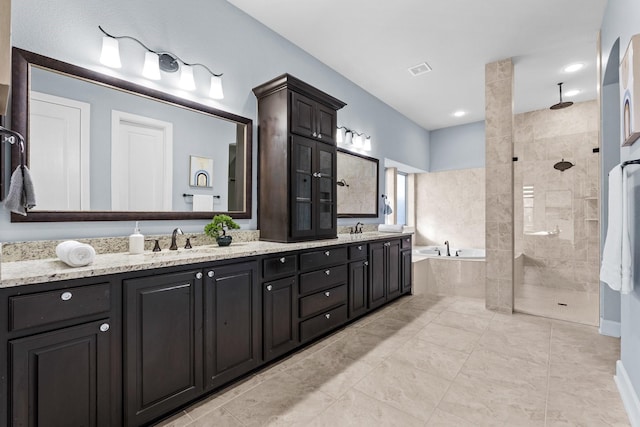 full bathroom with a sink, double vanity, a bath, and tiled shower