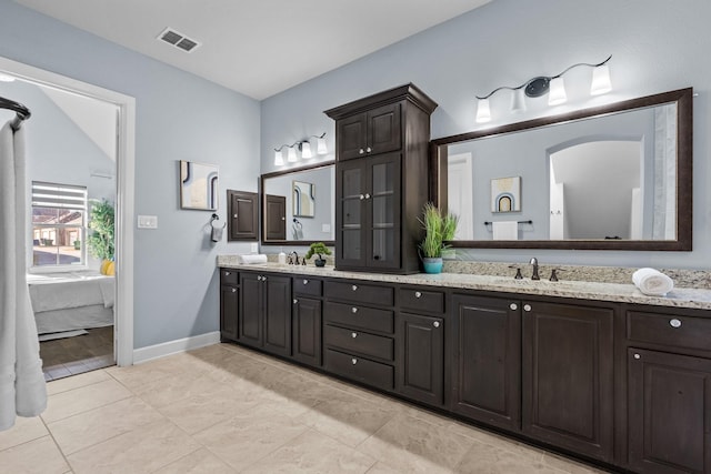 full bath featuring ensuite bathroom, double vanity, a sink, and visible vents