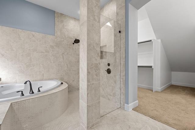 full bathroom featuring baseboards, a spacious closet, a bath, and walk in shower