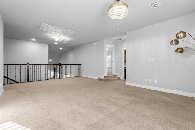 carpeted empty room with baseboards, recessed lighting, visible vents, and attic access