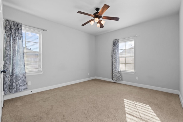 unfurnished room with carpet, baseboards, and a ceiling fan