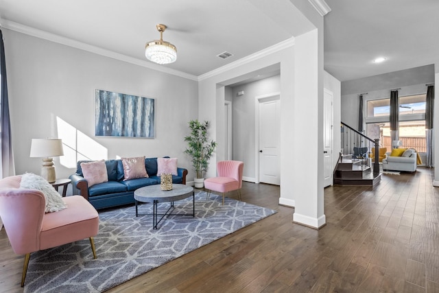 living room featuring baseboards, visible vents, stairway, wood finished floors, and crown molding