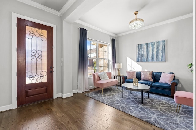 entrance foyer featuring ornamental molding, wood-type flooring, and baseboards