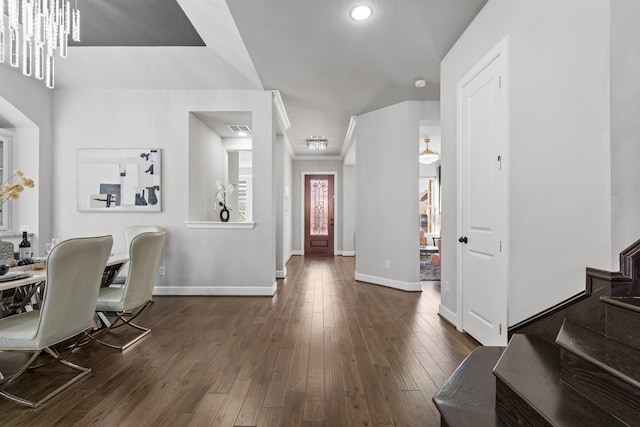 entryway featuring stairs, baseboards, dark wood-type flooring, and ornamental molding