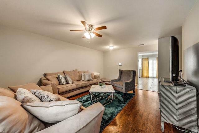 living room with wood-type flooring and ceiling fan