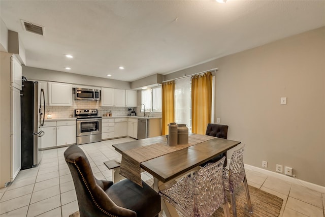 dining area with sink and light tile patterned floors