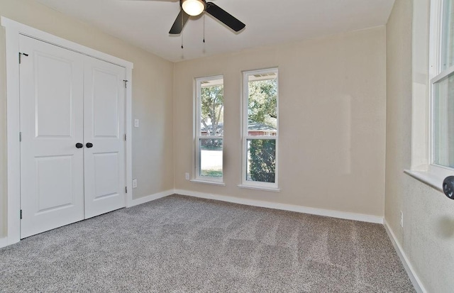 unfurnished bedroom featuring ceiling fan, carpet flooring, and a closet