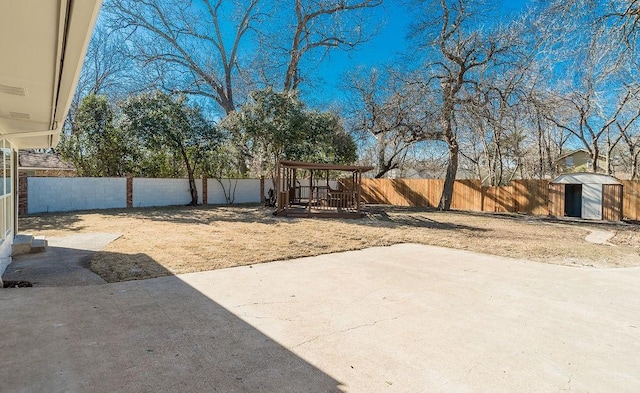 view of yard with a shed, a patio area, and a playground